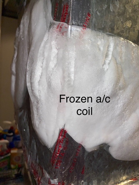 Frozen air conditioning coil covered in ice, indicating a malfunction